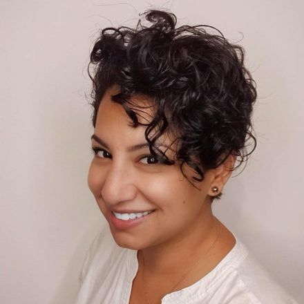 Headshot pose of woman with short curly hair