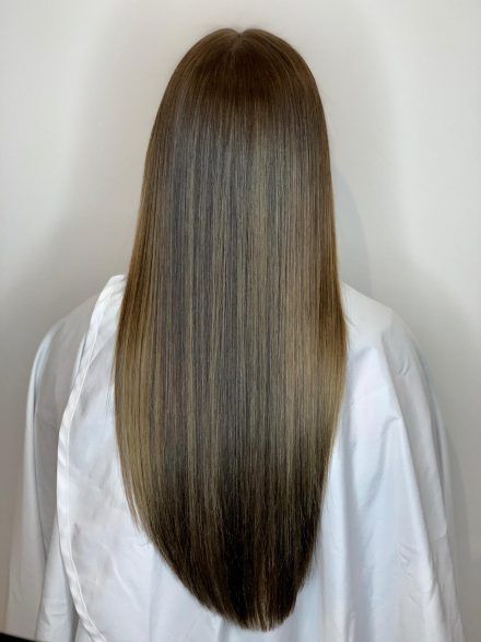 Back view of long brunette straight styled hair